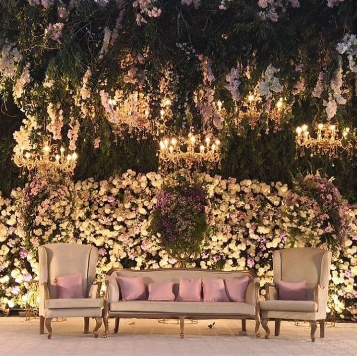 An enchanting wedding stage embellished with vibrant purple and white flowers, setting a charming backdrop for the ceremony.