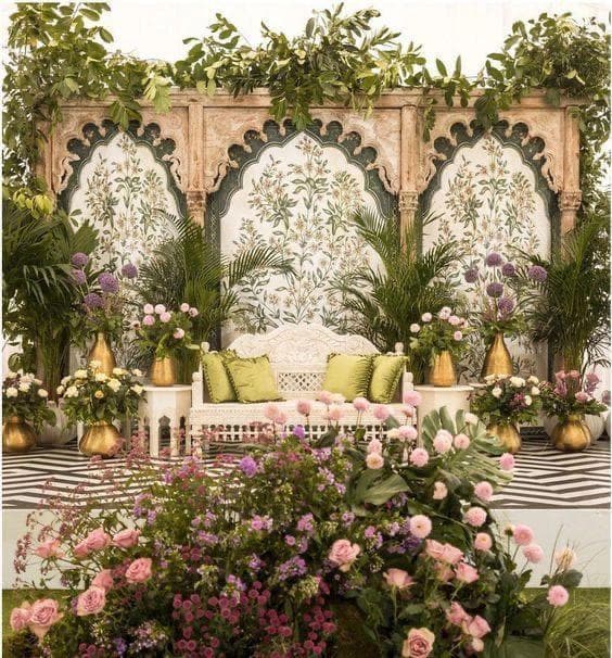 A floral display featuring a couch, with a wall adorned in various colorful floral arrangements, enhancing the decor.
