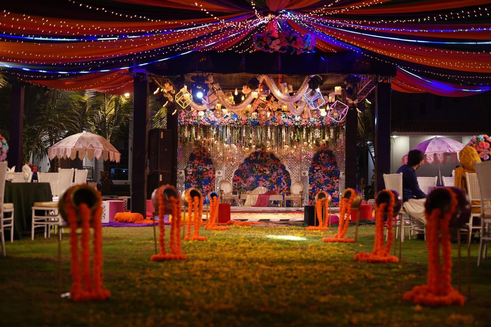 A beautifully decorated wedding ceremony featuring orange and yellow accents, enhancing the celebratory mood.