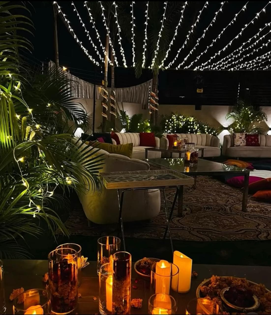 A beautifully lit patio featuring candles and decorative lights, perfect for an evening gathering.